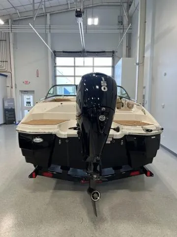 Slide: The Image of 2024 NauticStar 203 DC boat with 150 HP outboard motor in showroom. - 6