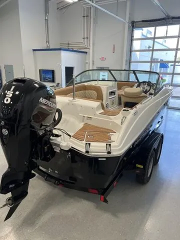 Slide: The Image of 2024 NauticStar 203 DC boat with Mercury 150 outboard motor in showroom. - 7