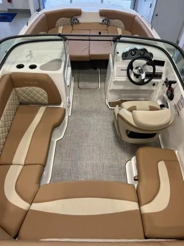 Slide: The Image of 2024 NauticStar 203 DC boat interior with tan and cream seating. - 8