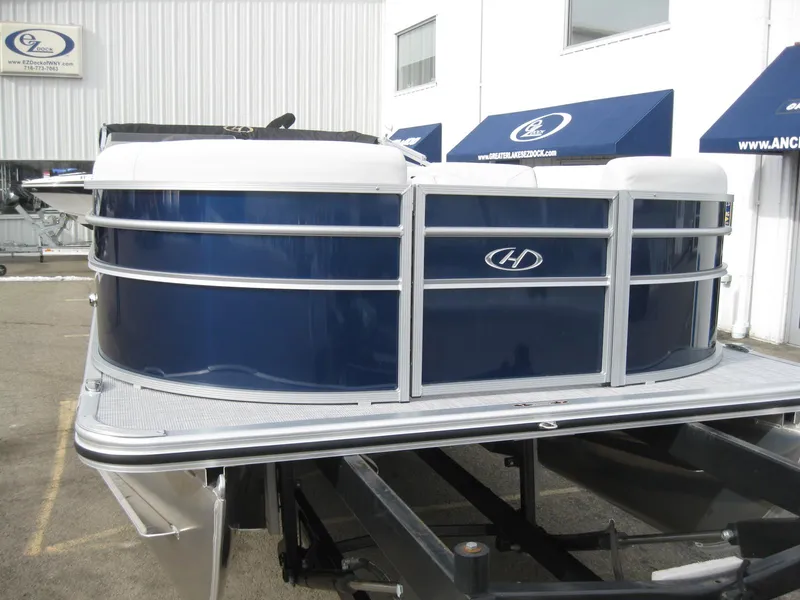 Slide: The Image of 2023 Harris FloteBote Cruiser 230 pontoon boat in blue and white. - 3