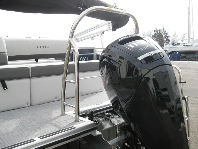 Slide: The Image of 2023 Harris FloteBote Cruiser 230 with Mercury outboard motor and stainless steel ladder. - 6