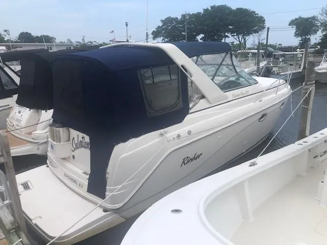The Image of 2003 Rinker Fiesta Vee 270 boat docked at a marina. - 0