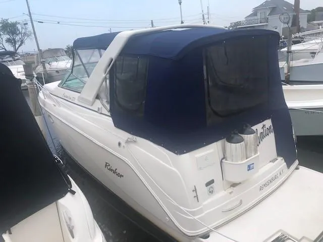 Slide: The Image of 2003 Rinker Fiesta Vee 270 boat docked with blue canvas cover. - 1