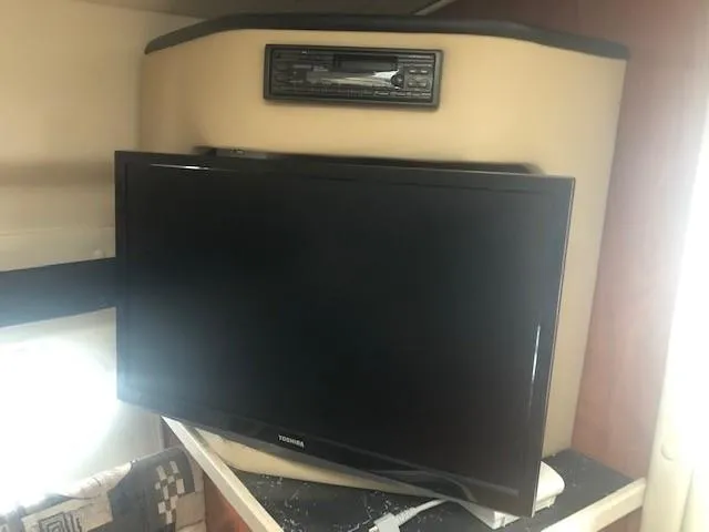 Slide: The Image of Flat-screen TV and stereo system inside a 2003 Rinker Fiesta Vee 270 boat. - 12