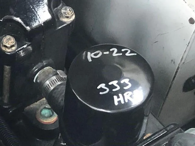 Slide: The Image of Close-up of 2003 Rinker Fiesta Vee 270 engine with oil filter marked 10-22, 333 HRS. - 15