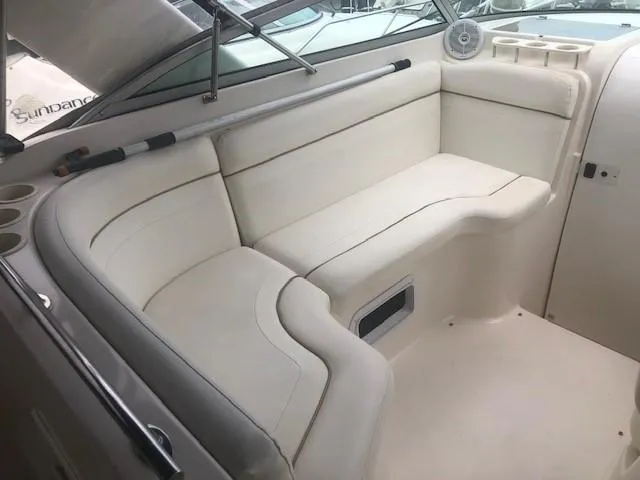 Slide: The Image of 2003 Rinker Fiesta Vee 270 boat interior with white cushioned seating. - 4