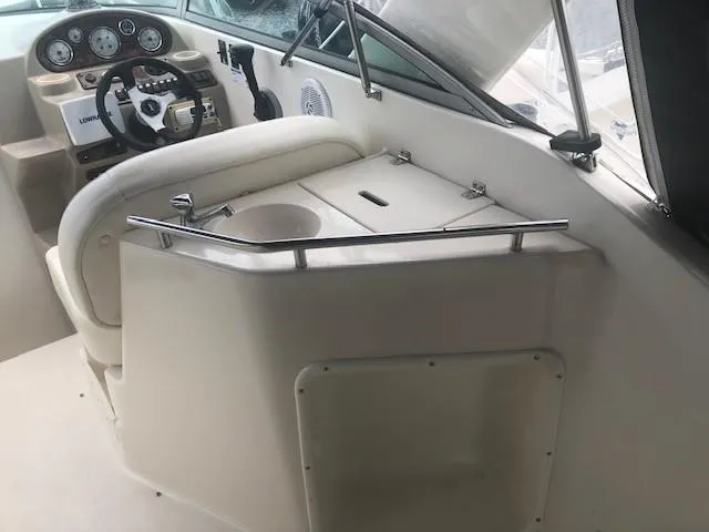 Slide: The Image of 2003 Rinker Fiesta Vee 270 boat cockpit with steering wheel and control panel. - 5
