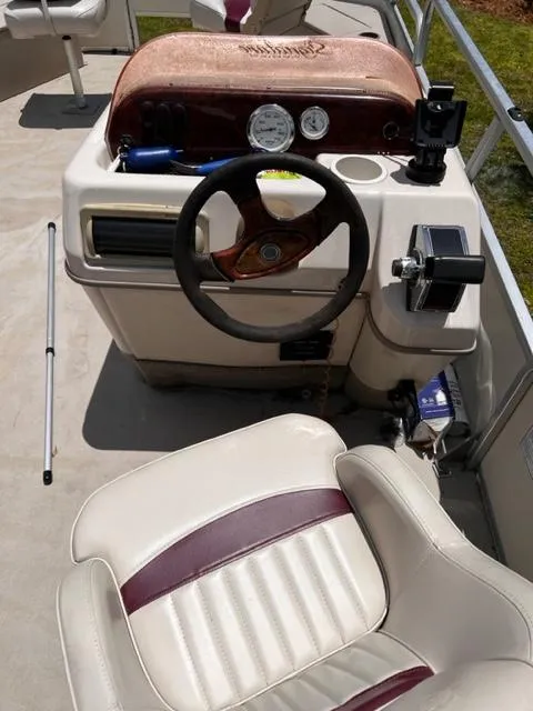Slide: The Image of 2007 Sun Tracker Bass Buggy boat dashboard and captain's chair. - 2