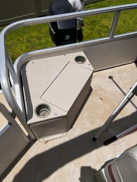 Slide: The Image of 2007 Sun Tracker Bass Buggy boat interior with storage compartment and cup holders. - 4