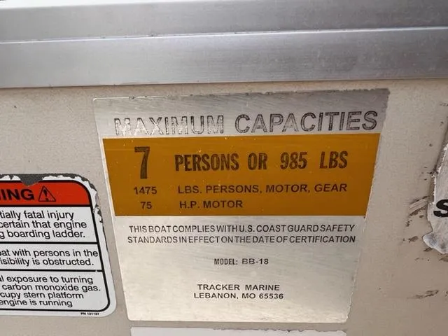 Slide: The Image of 2007 Sun Tracker Bass Buggy capacity label: 7 persons or 985 lbs, 75 HP motor. - 7
