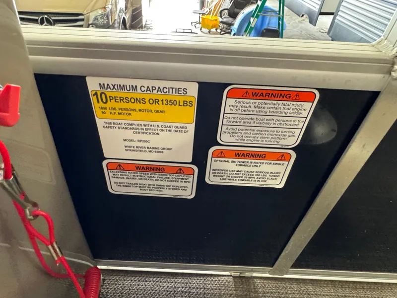 Slide: The Image of Ranger 200C 2021 boat capacity and warning labels, maximum 10 persons or 1350 lbs. - 12