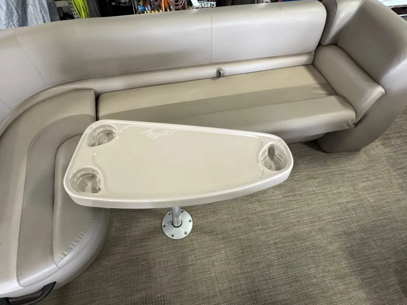 Slide: The Image of 2021 Ranger 200C boat interior with beige seating and a triangular table. - 15