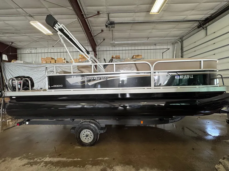 Slide: The Image of 2021 Ranger 200C pontoon boat in a warehouse setting. - 2