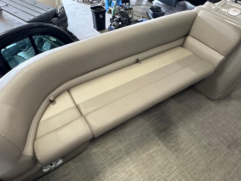 Slide: The Image of 2021 Ranger 200C boat interior with beige seating and carpeted flooring. - 6