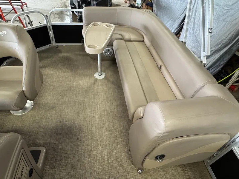 Slide: The Image of Interior of 2021 Ranger 200C boat with beige seating and small table. - 8
