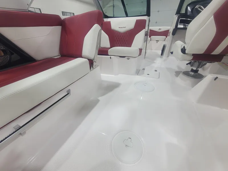 Slide: The Image of 2024 MasterCraft XT24 boat interior with red and white seating. - 10