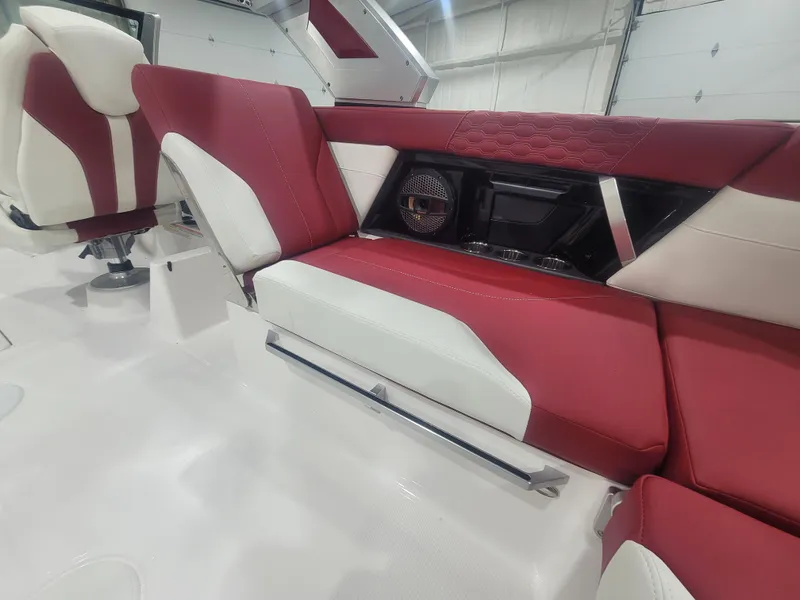 Slide: The Image of 2024 MasterCraft XT24 boat interior with red and white seating. - 11