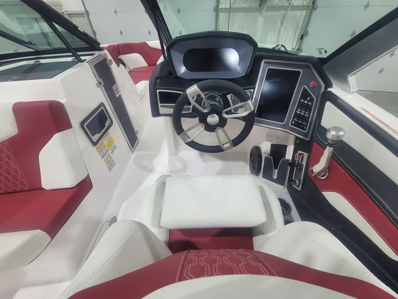 Slide: The Image of 2024 MasterCraft XT24 boat interior with modern dashboard and red-white seating. - 14