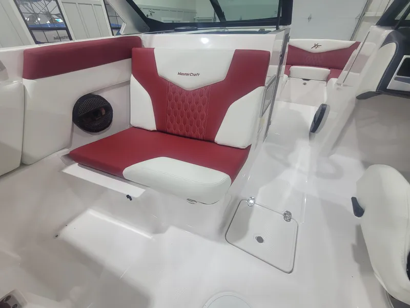 Slide: The Image of 2024 MasterCraft XT24 boat interior with red and white seating. - 15