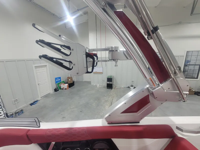 Slide: The Image of 2024 MasterCraft XT24 boat interior with wakeboard rack in a garage. - 16