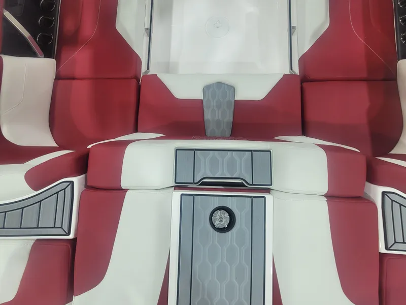 Slide: The Image of 2024 MasterCraft XT24 boat interior with red and white seating and grey accents. - 17
