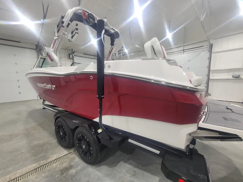 Slide: The Image of 2024 MasterCraft XT24 boat in a showroom, red and white exterior. - 21