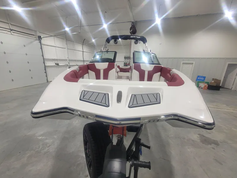 Slide: The Image of 2024 MasterCraft XT24 boat in a showroom, front view. - 3
