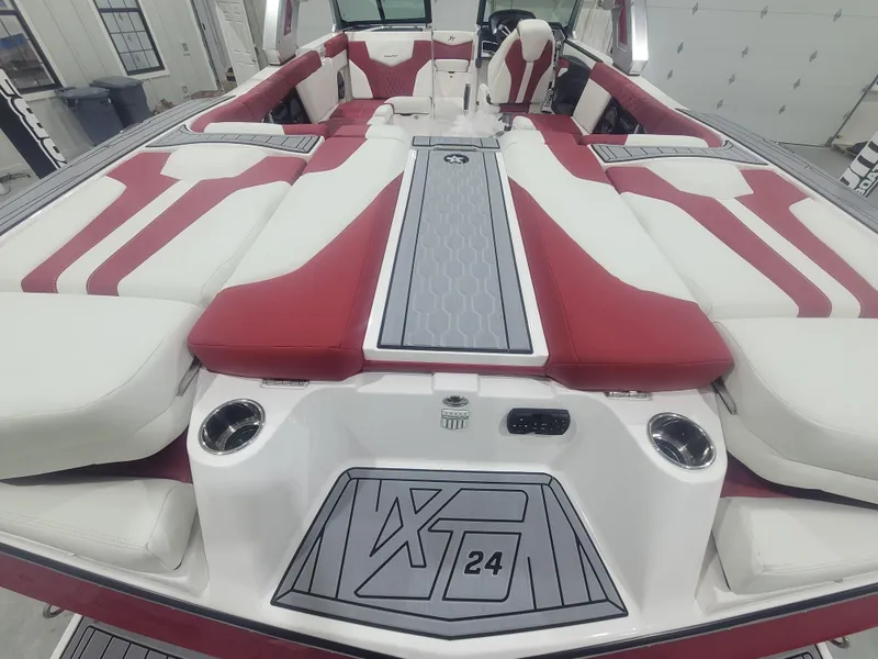 Slide: The Image of 2024 MasterCraft XT24 boat interior with red and white seating. - 7