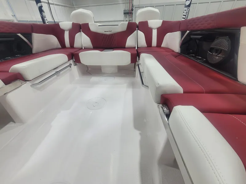 Slide: The Image of 2024 MasterCraft XT24 boat interior with red and white seating. - 9