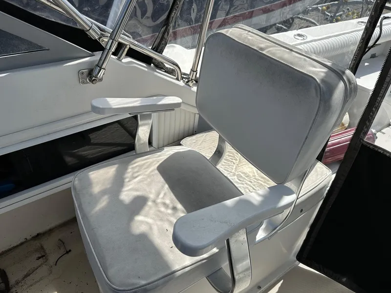 Slide: The Image of 1994 Robalo 2160 Cuddy Cabin boat captain's chair in cockpit. - 11