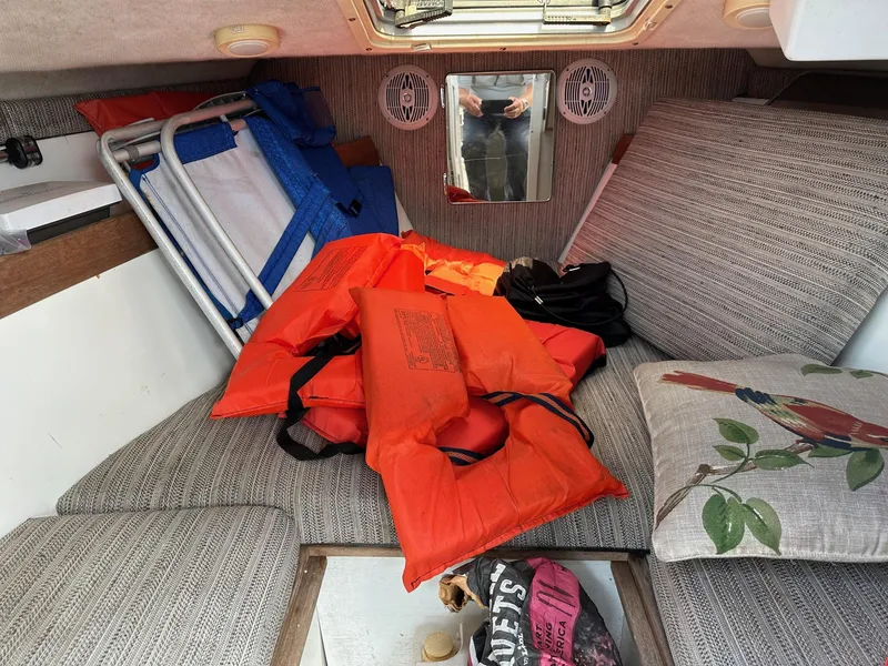 Slide: The Image of 1994 Robalo 2160 Cuddy Cabin interior with life jackets and cushions. - 13