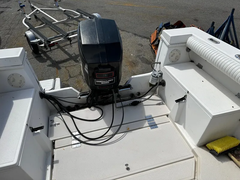 Slide: The Image of 1994 Robalo 2160 Cuddy Cabin boat stern with outboard motor and trailer. - 5