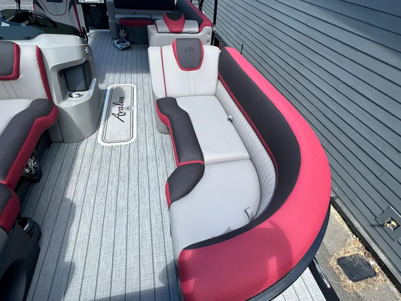 Slide: The Image of 2024 Avalon LSZ 2385 CRB boat interior with red and gray seating. - 10