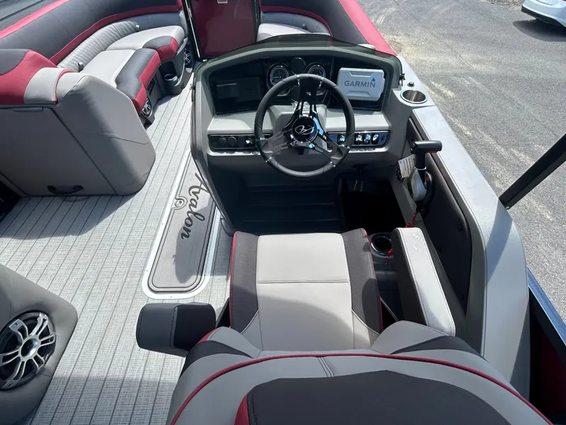 Slide: The Image of 2024 Avalon LSZ 2385 CRB boat interior with steering console and seating. - 16