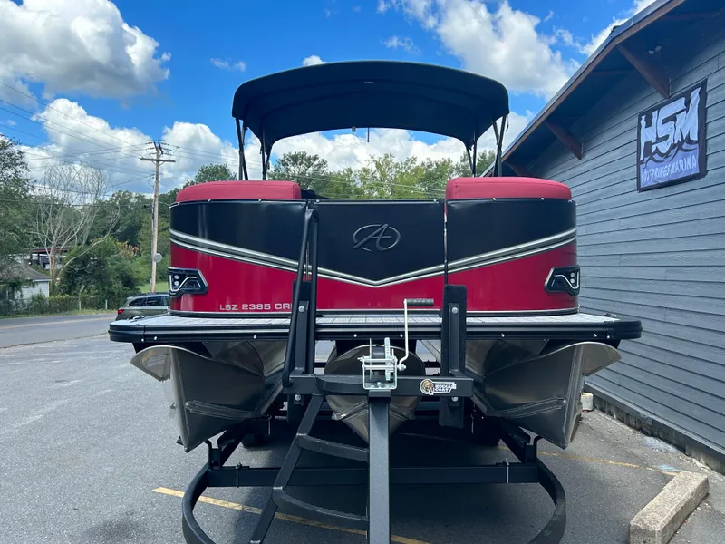 Slide: The Image of 2024 Avalon LSZ 2385 CRB pontoon boat on trailer, rear view. - 2