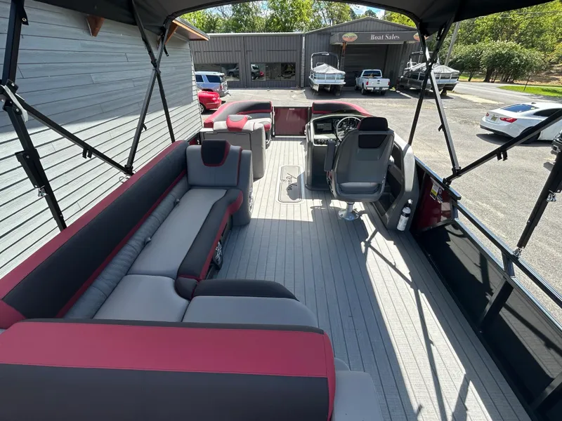Slide: The Image of 2024 Avalon LSZ 2385 CRB pontoon boat interior with red and gray seating. - 21