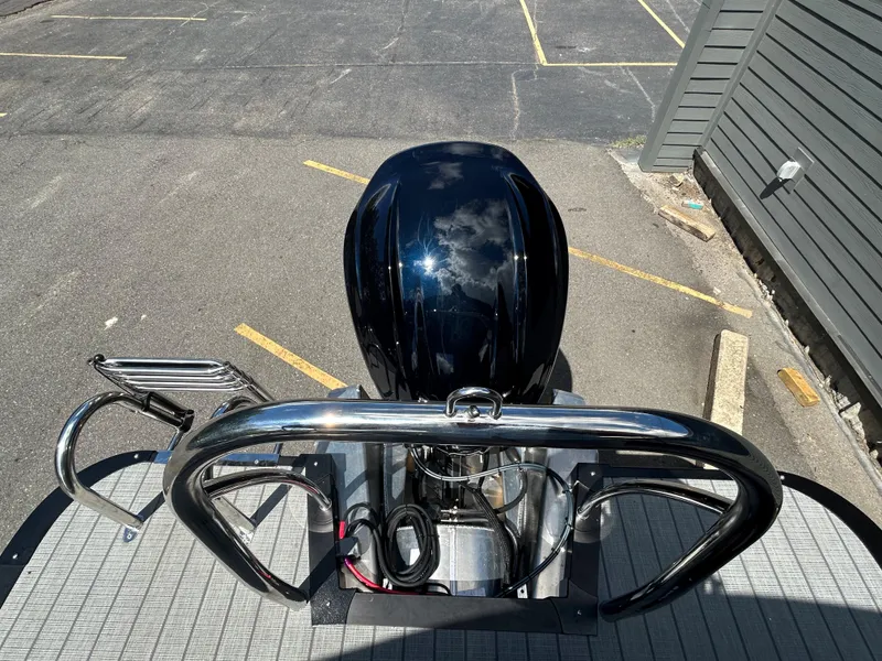 Slide: The Image of 2024 Avalon LSZ 2385 CRB boat rear view with outboard motor and stainless steel railing. - 22