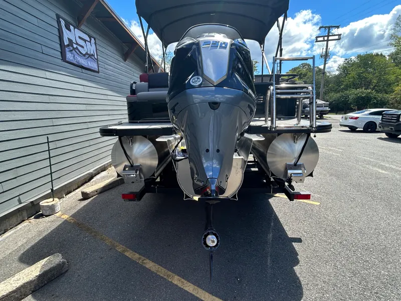 Slide: The Image of 2024 Avalon LSZ 2385 CRB pontoon boat with outboard motor in parking lot. - 6