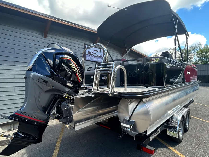 Slide: The Image of 2024 Avalon LSZ 2385 CRB pontoon boat with outboard motor on trailer. - 7