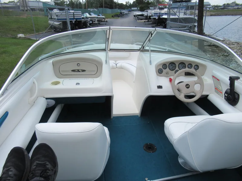 Slide: The Image of 1997 Sea Ray 185 Bow Rider interior with white seats and blue carpet. - 11