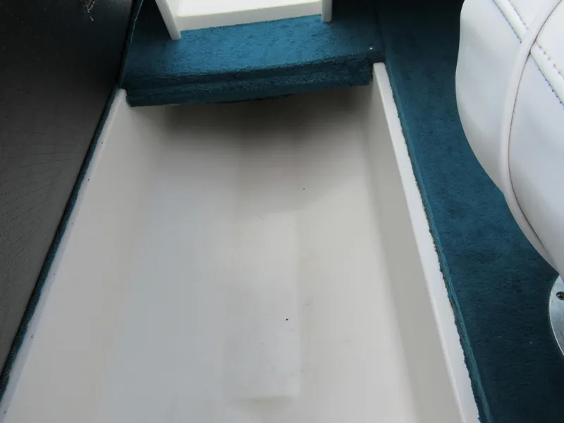 Slide: The Image of Interior view of 1997 Sea Ray 185 Bow Rider boat with blue carpet and white seating. - 15