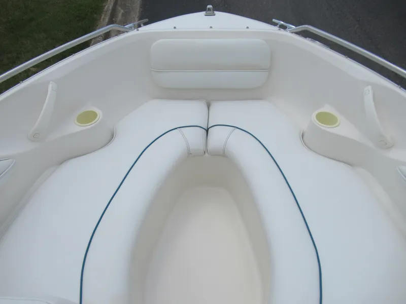 Slide: The Image of 1997 Sea Ray 185 Bow Rider boat interior with white cushioned seating. - 16