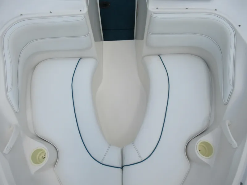 Slide: The Image of 1997 Sea Ray 185 Bow Rider white cushioned seating area. - 17