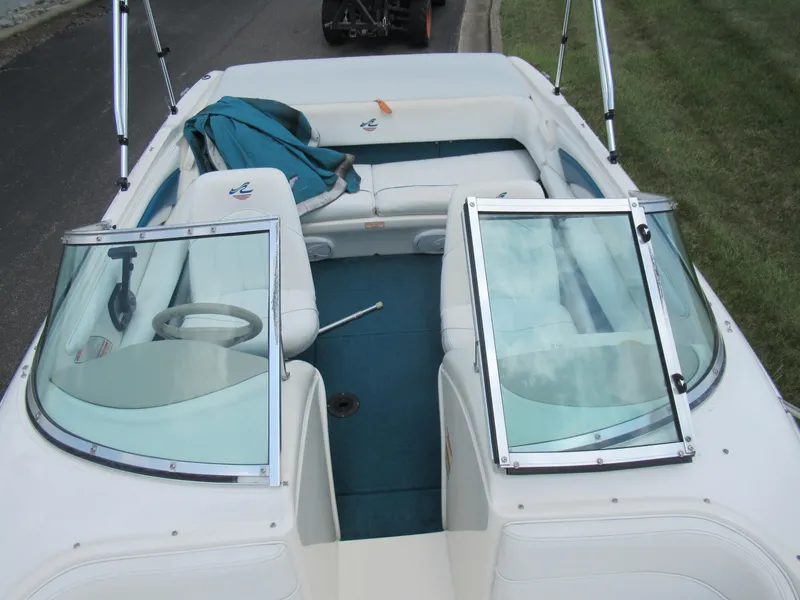Slide: The Image of 1997 Sea Ray 185 Bow Rider boat interior with open windshield and seating. - 18