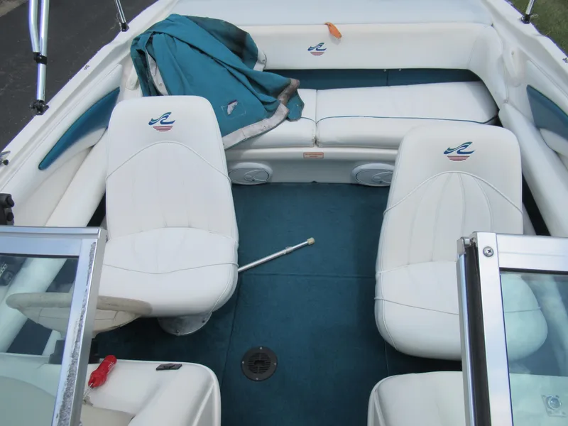 Slide: The Image of 1997 Sea Ray 185 Bow Rider interior with white seats and blue carpet. - 19