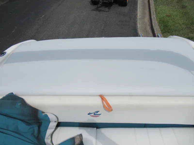 Slide: The Image of 1997 Sea Ray 185 Bow Rider boat interior with white and teal upholstery. - 21