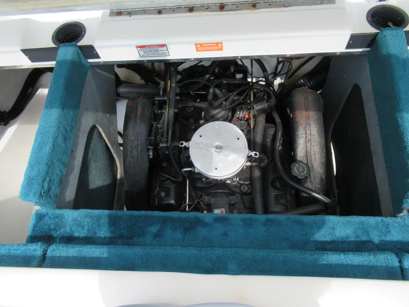 Slide: The Image of 1997 Sea Ray 185 Bow Rider engine compartment with blue carpeted sides. - 22