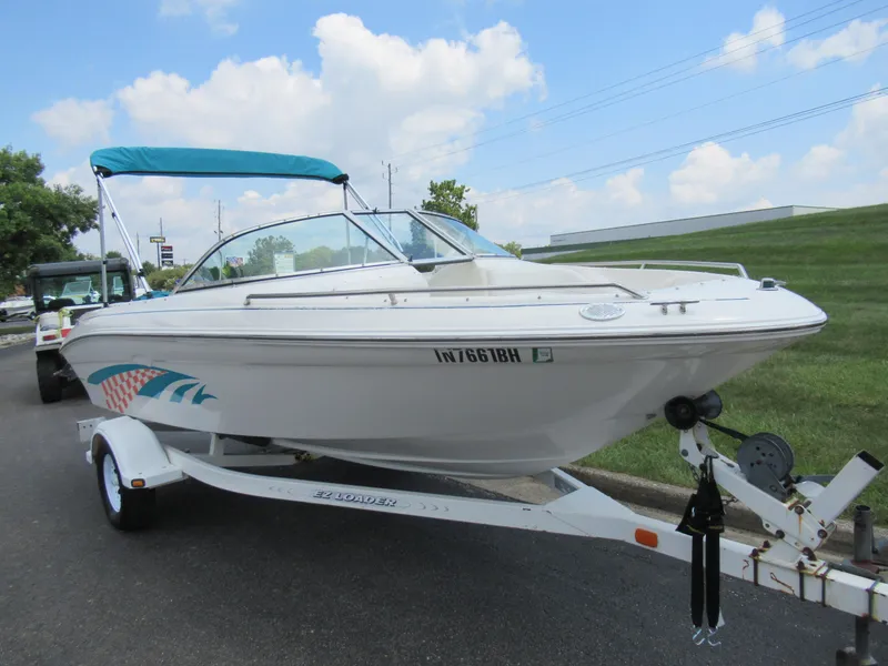 Slide: The Image of 1997 Sea Ray 185 Bow Rider boat on a trailer with blue canopy. - 5