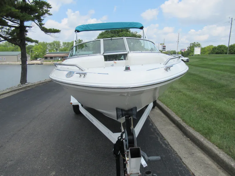 Slide: The Image of 1997 Sea Ray 185 Bow Rider boat on trailer, front view, blue sky background. - 6