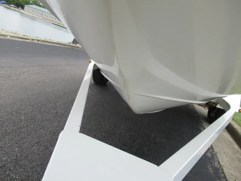 Slide: The Image of 1997 Sea Ray 185 Bow Rider on a trailer near a waterfront. - 7